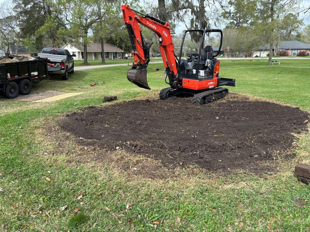Mini excavator digging earth in a residential yard, preparing for landscaping project.